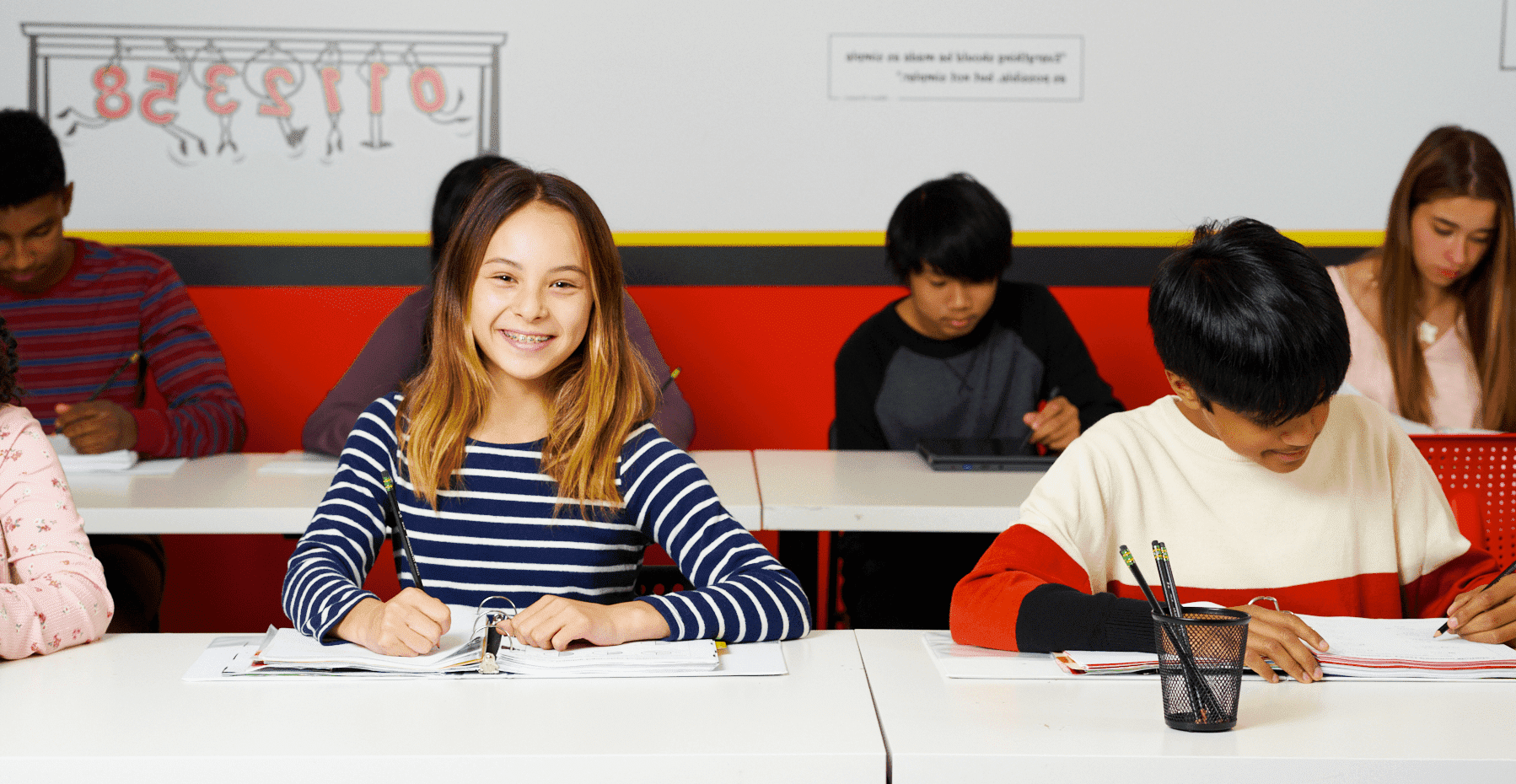 Students writing out math solutions during a classroom exercise