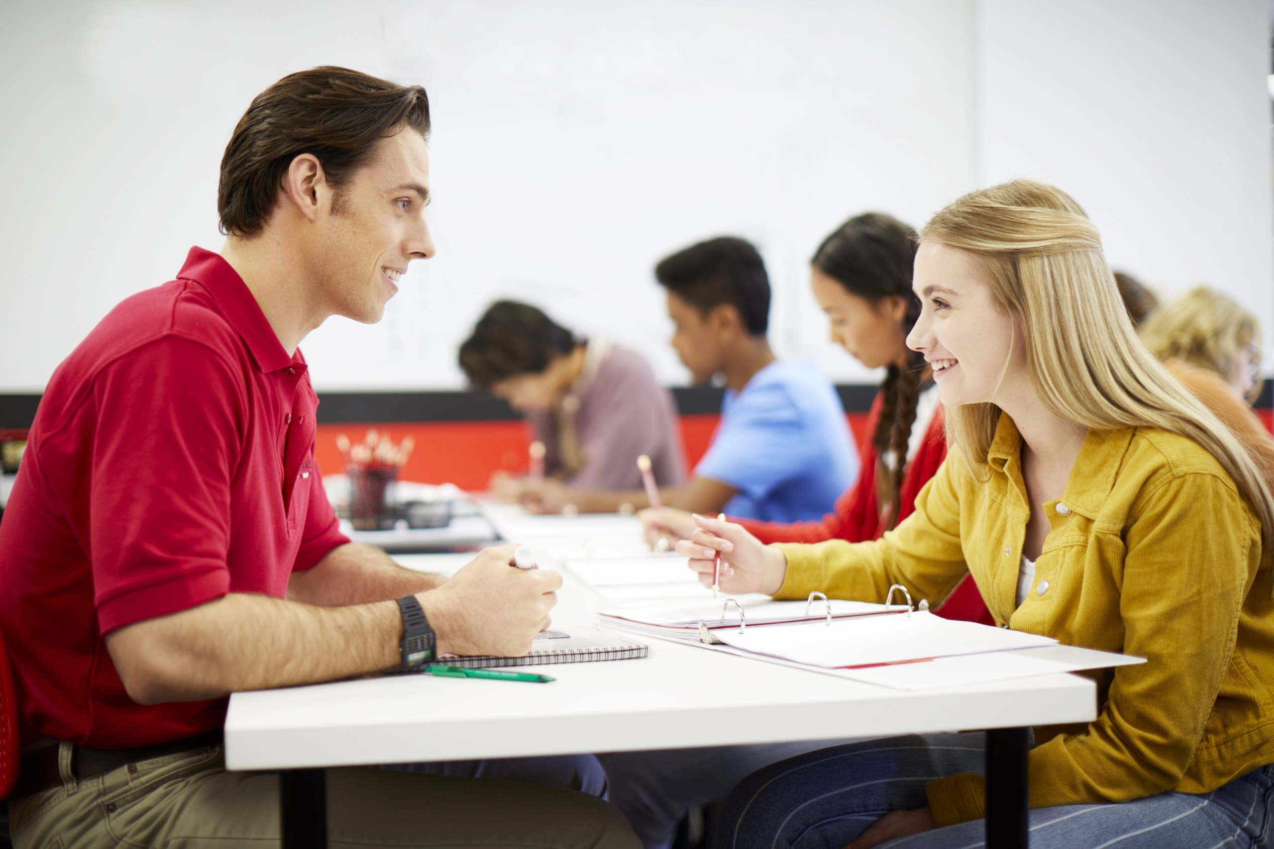 Engaged 12th grade student learning math with tutor