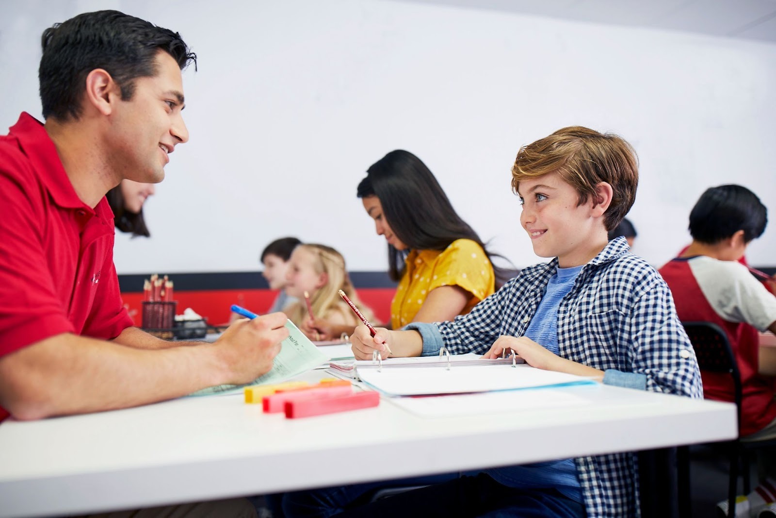 Mathnasium math tutor solving a math problem with a student.