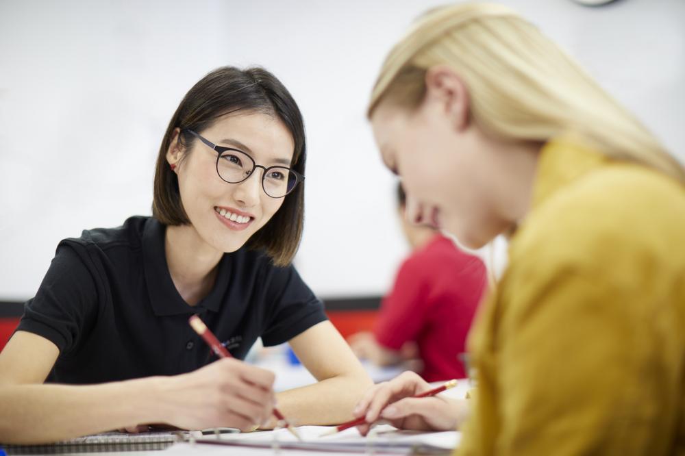 Mathnasium tutor helping student with math problem.