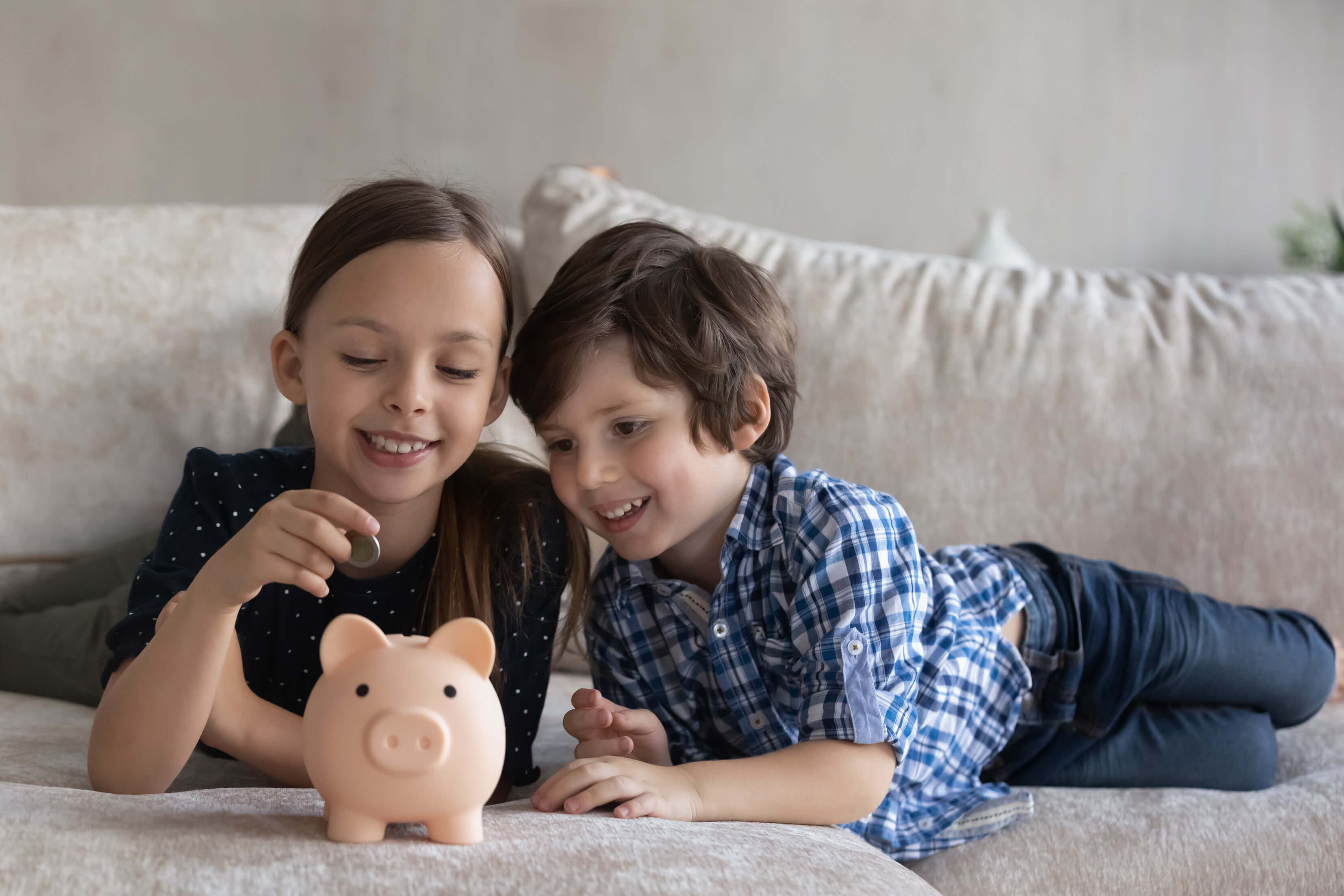 two kids with a piggy bank