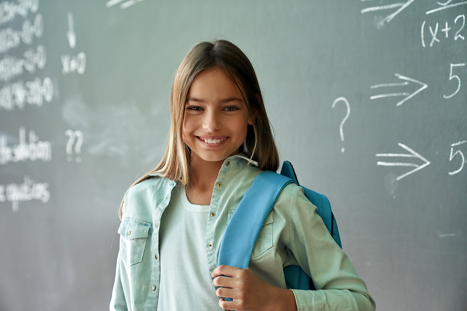 Girl with backpack at school.