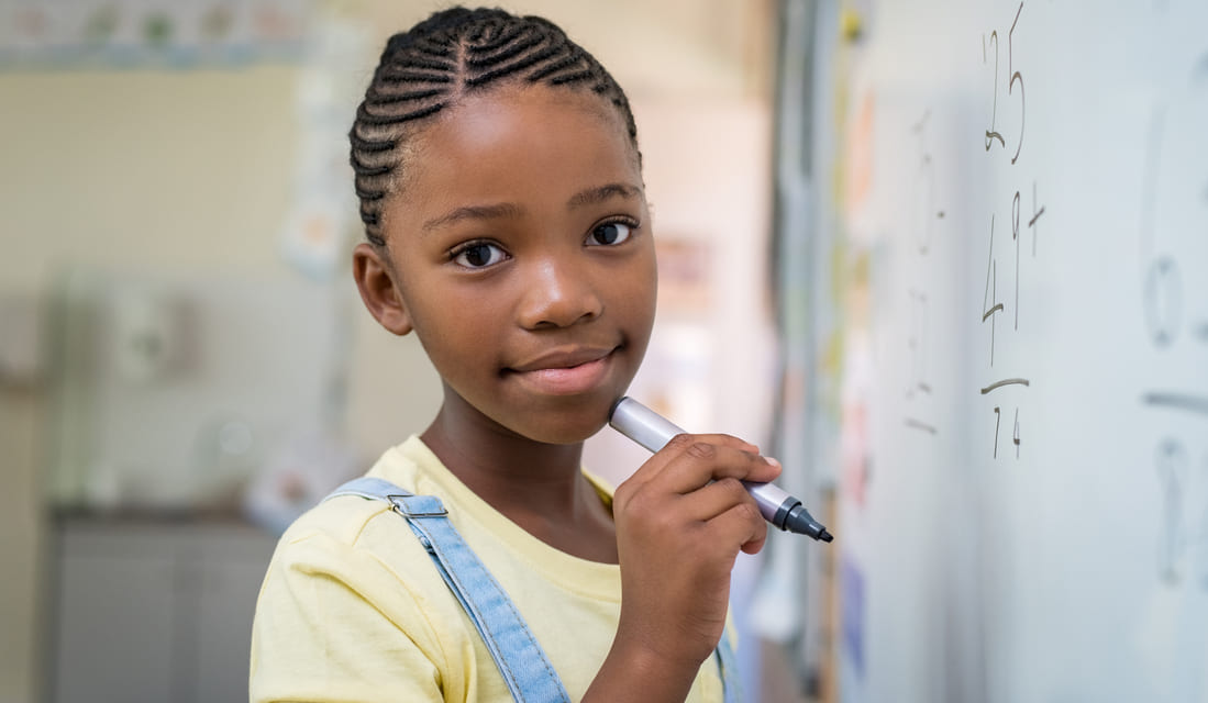 A confident math student, working on a math task in front of the whiteboard