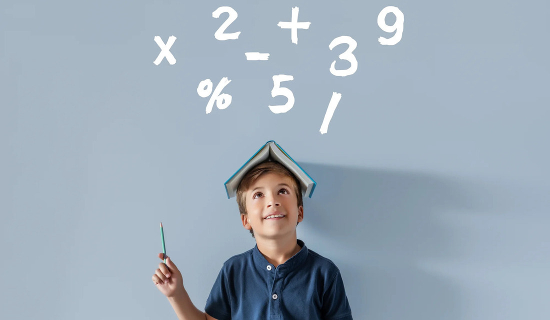 A boy, pencil in hand, looks up at a number sign, reflecting interest in numbers or learning activities.